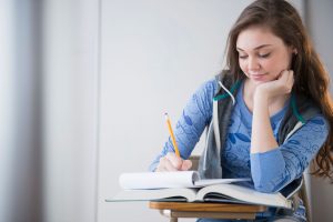 Hispanic Girl Studying At Desk